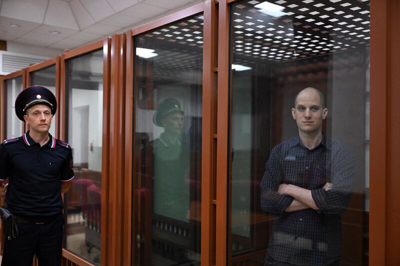 US journalist Evan Gershkovich, accused of espionage, looks out from inside a glass defendants' box prior to a hearing in Yekaterinburg's Sverdlovsk Regional Court on Wednesday. Photograph: Natalia Kolesnikova/AFP via Getty Images