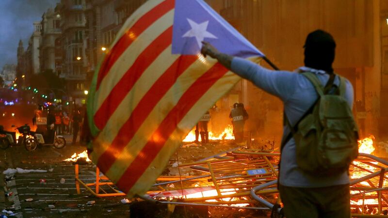 People wave ‘Esteladas’ flag, the unofficial flag typically flown by Catalan independence supporters,  in Barcelona on Friday. Photograph: Quique Garcia/EPA.