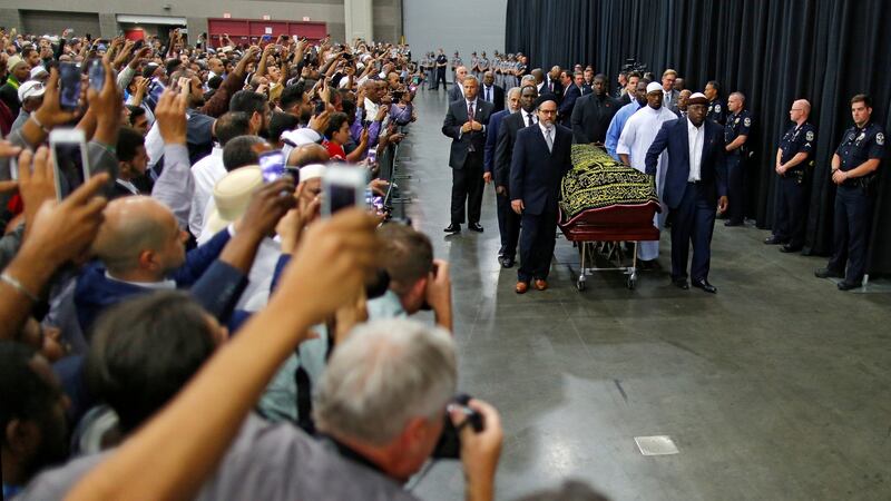 Worshipers and well-wishers take photographs as the casket with the body of the late boxing champion Muhammad Ali is brought for his jenazah, an Islamic funeral prayer, in Louisville, Kentucky. Photograph: Carlos Barria/Reuters.