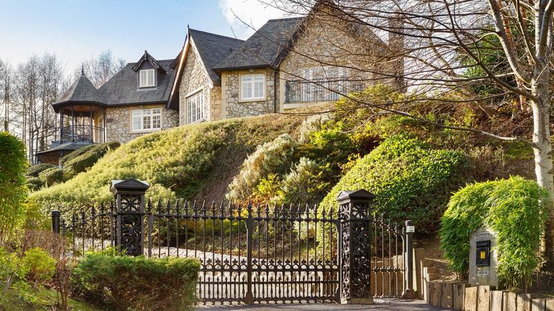 The gardens have matured considerably since the house was last on the market. It is now surrounded by tall hedges, the sweeping driveway is fringed by lush borders and the deep sandstone patio rises to a lawned area