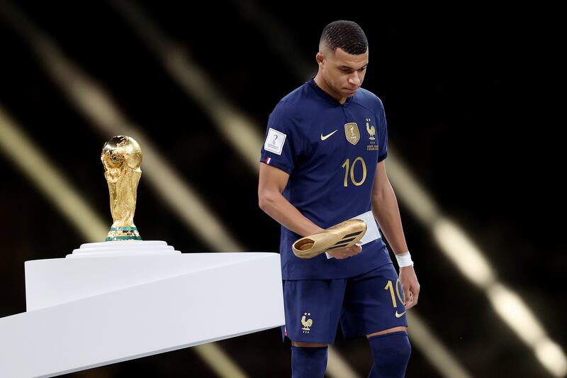 Kylian Mbappé of France walks past the World Cup trophy with his Golden Boot award. Mbappé scored eight goals in the tournament, and a hat-trick in the final, but still ended up on the losing side. Photograph: Julian Finney/Getty