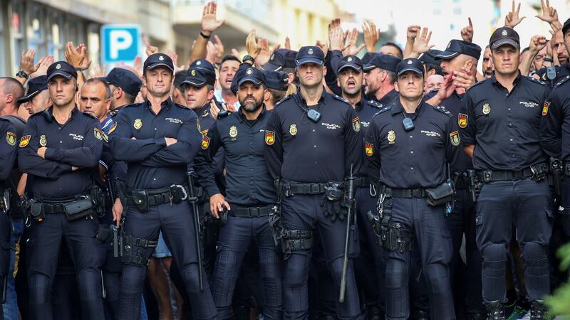 Spanish national police   stand outside their hotel as locals protest against their presence in  Pineda de Mar, north of Barcelona. Photograph: Albert Gea/Reuters