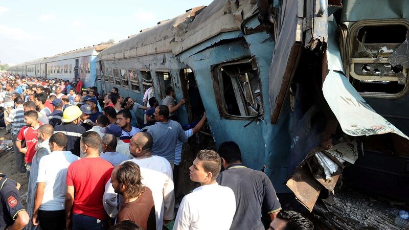 People gather at the site of a train collision in the area of Khorshid, in Egypt’s Mediterranean city of Alexandria. Photograph: AFP/Getty Images