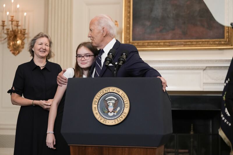 US president Joe Biden hugs the 12-year-old daughter of Aslu Kurmasheva, one of the people freed in the prisoner exchange with Russia, as he delivers remarks in the East Room at the White House in Washington DC on Thursday. Photograph: Eric Lee/The New York Times
                      
