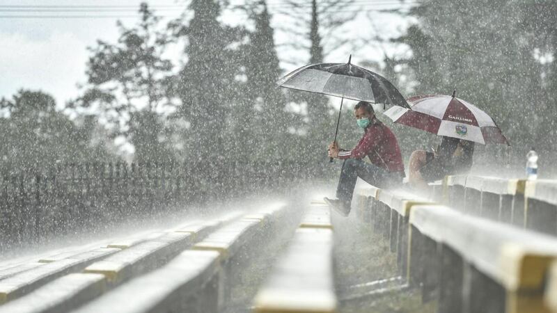 Galway supporter Des Casey from Ballybane shelters from the deluge before the Connacht SFC game against Roscommon at Dr Hyde Park. Photograph: Sam Barnes/Sportsfile from A Season of Sundays  Galway supporter Des Casey from Ballybane shelters from the deluge before the Connacht SFC game against Roscommon at Dr Hyde Park. Photograph: Sam Barnes/Sportsfile from A Season of Sundays