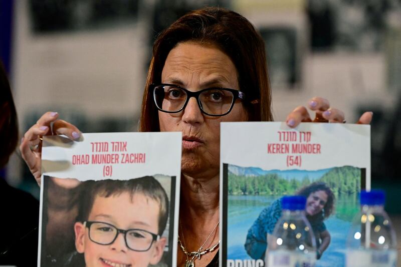 Israeli citizen Merav Mor Raviv holds a sign depicting Ohad Munder Zachri and Keren Munderheld hostages by Hamas militants following the October 7 attack. Photograph: Javier Soriano/AFP via Getty Images