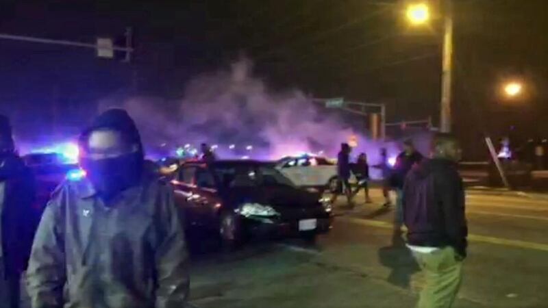 A frame grab from a video of locals standing near the site where a policeman allegedly shot a teenager at a gas station in Berkeley, St Louis, Missouri. Photograph: Leigh Maibes/EPA