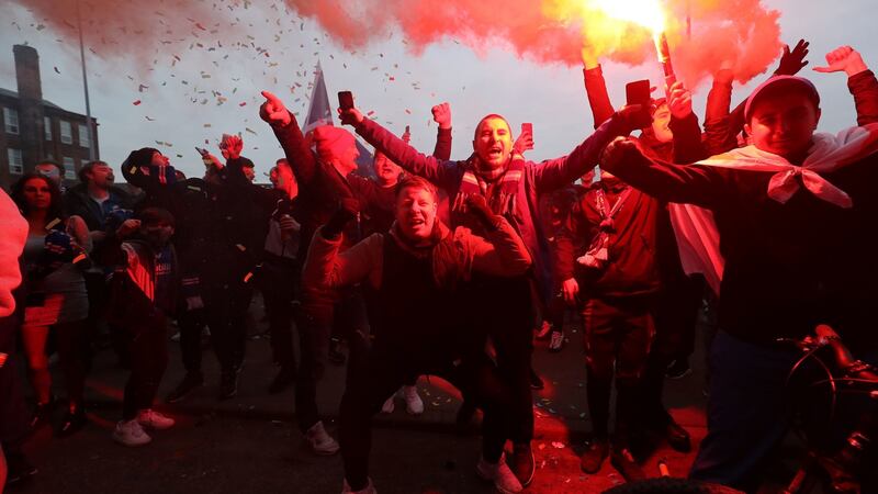 Rangers fans celebrate after the win. Photo: Jane Barlow/PA Wire