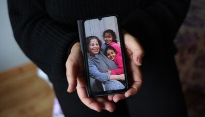 Sherin Alsabbagh holds her phone with a photograph of her mother Najwa. Also pictured are grandchildren Najwa (8) and Salsabeel (6). Photograph: Bryan O’Brien/The Irish Times
