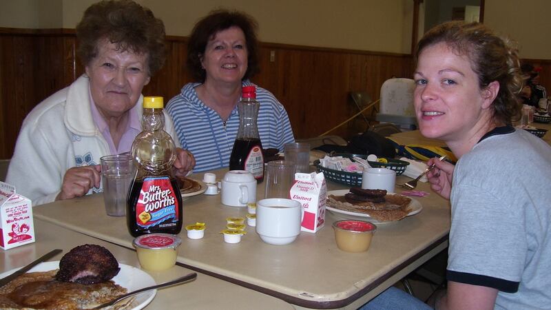 Patricia Hopper Patteson (centre) with her mother Elizabeth and  daughter Tara Meek eating buckwheat cakes at the Buckwheat Festival in Kingwood, West Virginia.