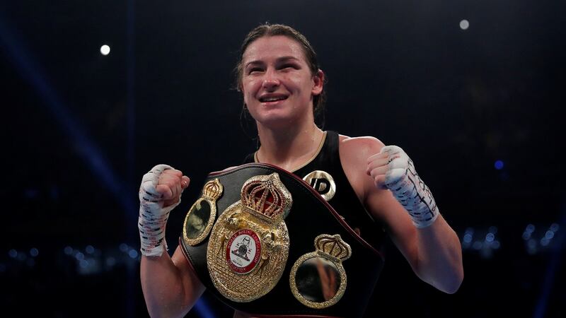 Katie Taylor celebrates with the belt at the end of the fight. Photograph: Andrew Couldridge/Reuters
