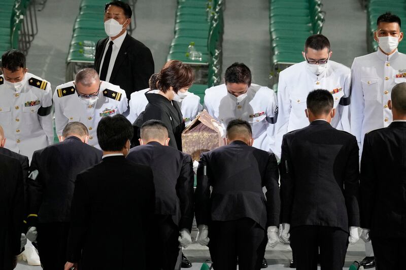 Honour guards bow as Akie Abe, widow of Japan's former prime minister Shinzo Abe, leaves with the cinerary urn containing his ashes at the end of his state funeral. Photograph: Eugene Hoshiko/AFP