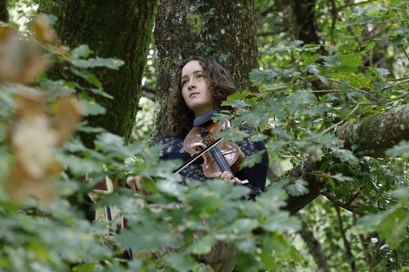 Kitty Lewis (UK) on fiddle: 'Workshops, side-jams and intense improvisations happen all day long, even at times among the trees.' Photograph: Nick Bradshaw/The Irish Times