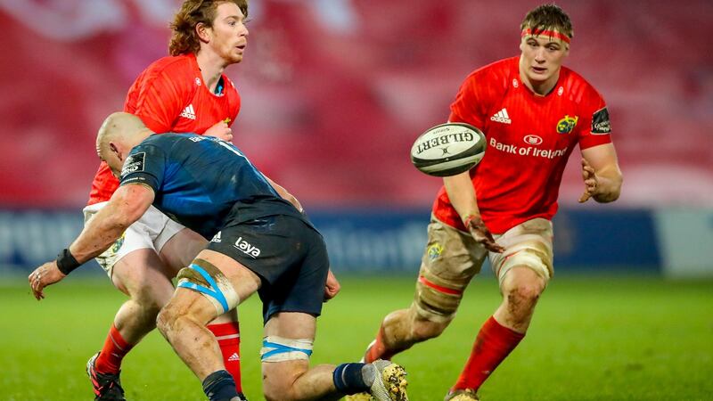 Munster’s Ben Healy offloads to Gavin Coombes as he comes up against Rhys Ruddock of Leinster in their Guinness Pro14 match at Thomond Park, Limerick on Saturday. Photograph: James Crombie/Inpho