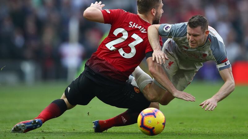James Milner of Liverpool battles for possession with Manchester United’s Luke Shaw. Photo: Clive Brunskill/Getty Images