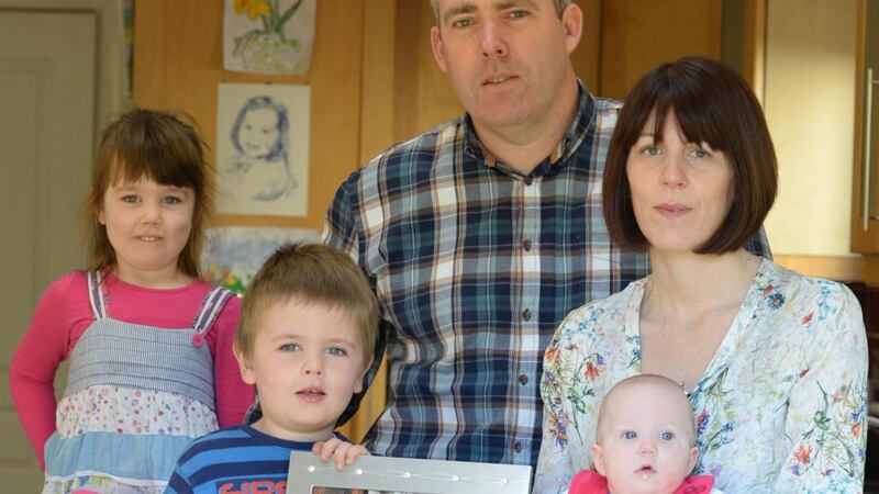 Adrian and Áine Hendrick with children Róisín (4), Eoin (3), Amy (5 months) and Aoife, in photograph, who died of leukemia in August 2012,  at home in Malahide, Co Dublin. Photograph: Dara Mac Dónaill