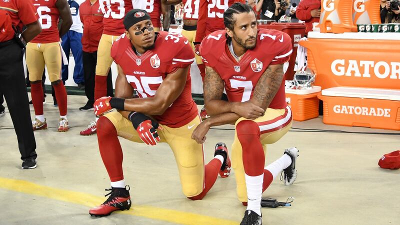 Eric Reid and Colin Kaepernick  of the San Francisco 49ers kneel in protest during the American anthem.
