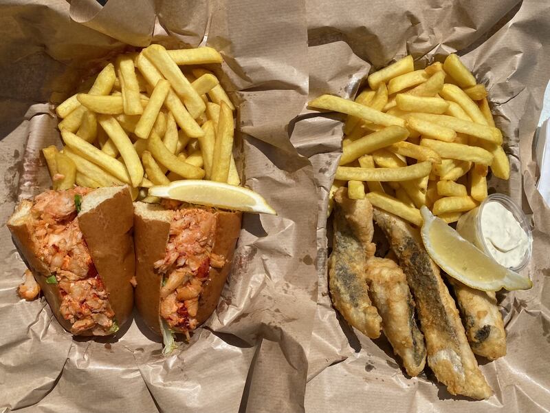 Hake goujons and a lobster roll in a brioche bun with chips