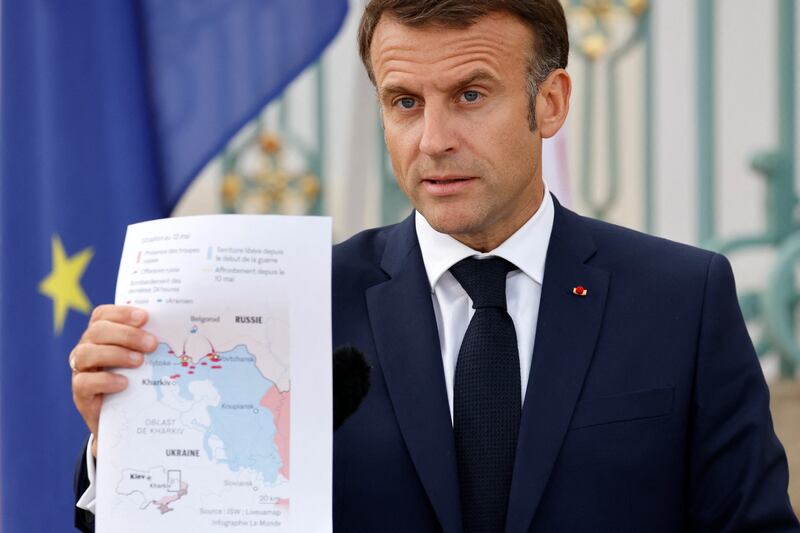 France's President Emmanuel Macron shows a map of the border between Ukraine and Russia during a joint press conference with the German chancellor, Olaf Scholz. Photograph:  Ludovic Marin/AFP/Getty 