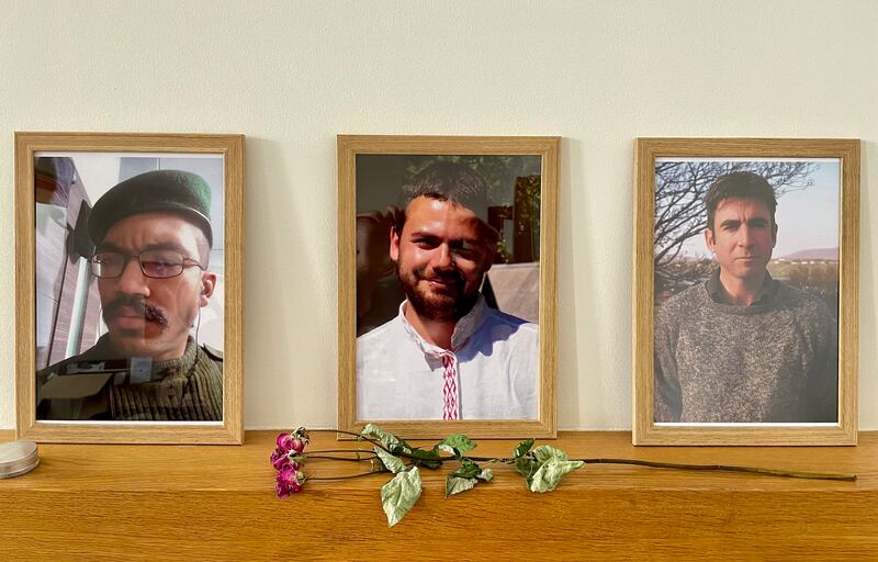 Photos of former US marine Cooper "Harris" Andrews, Russian anarchist activist Dmitry "Leshiy" Petrov and Finbar Cafferkey in the Kyiv office of Solidarity Collectives. Photograph: Daniel McLaughlin