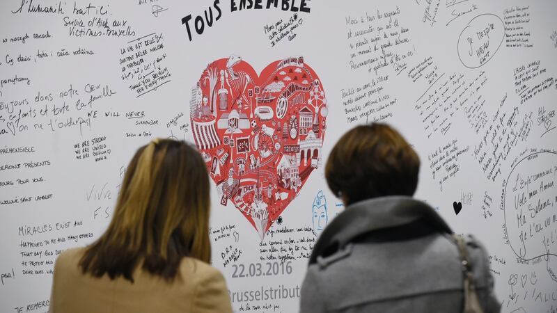 People read messages on a commemorative wall at the Maalbeek metro station. Photograph: JohnThysjohn/ AFP/Getty Images