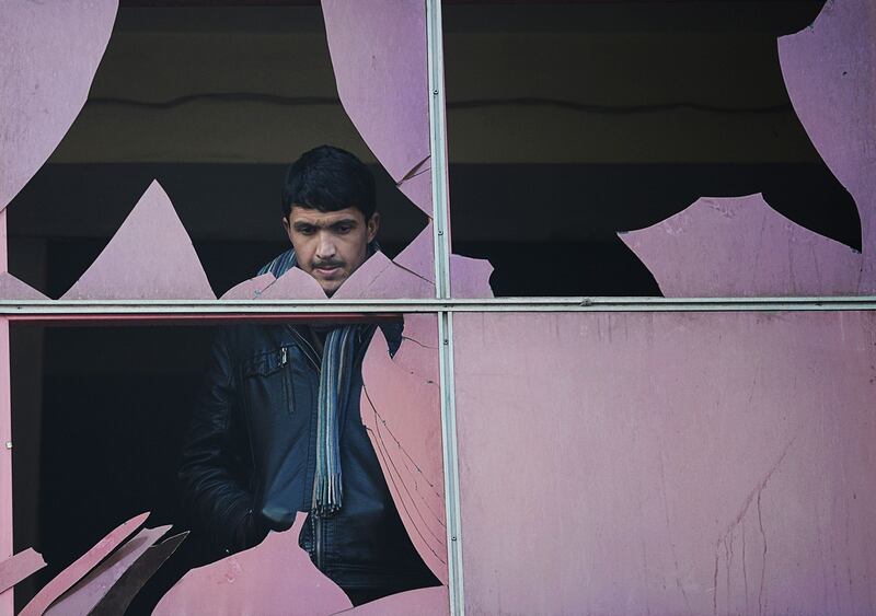 January 26th, 2014: An Afghan resident looks through a broken window at the site of a suicide attack in Kabul. Photograph: Shah Marai/AFP