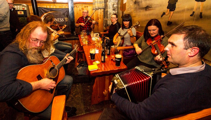A trad session in 2018 at the Patrick O’Keeffe Traditional Music Festival in Hartnett’s Bar, Castleisland, Co Kerry, involving (from left) Gearóid Ó Duinnín, Sarah Roche, Trish O’Dea, Donal O’Leary, Nollaig Ní Laoire, Cliodhna Ní Choisdealla, Aoife Ní Chaoimh and Paudie O’Connor. Photograph: John Reidy