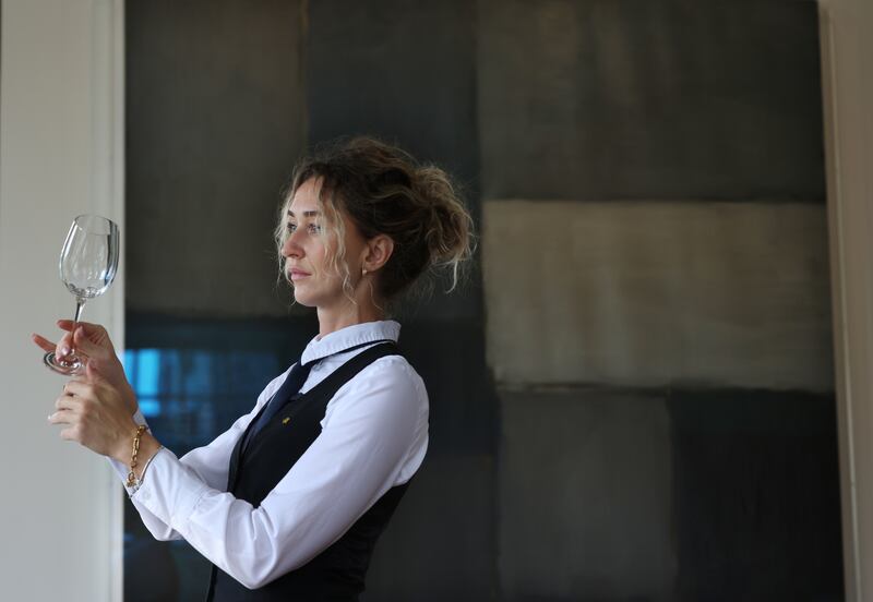 Diane Ihnatenko working in the Sean Scully Room of the Park Hotel Kenmare. Behind her is the Sean Scully painting ‘Moorland’.  Photo: Bryan O’Brien / The Irish Times 