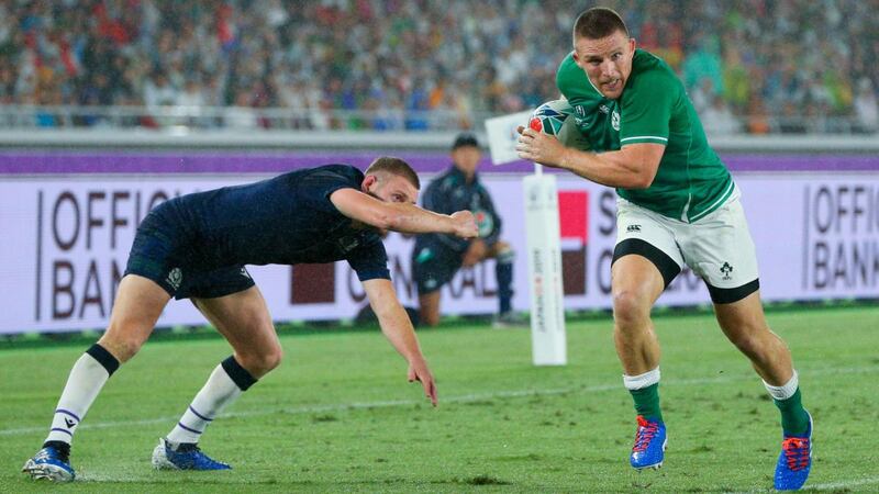 Andrew Conway scores Ireland’s fourth try ahead of Scotland’s Finn Russell. Photograph: Craig Mercer/Inpho