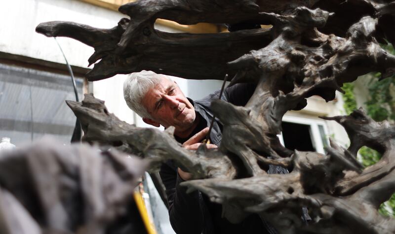 Brian O’Loughlin, the bog oak sculptor and artist, at work on a piece in his workshop near his home in Co Kildare. Photo: Bryan O'Brien/The Irish Times 