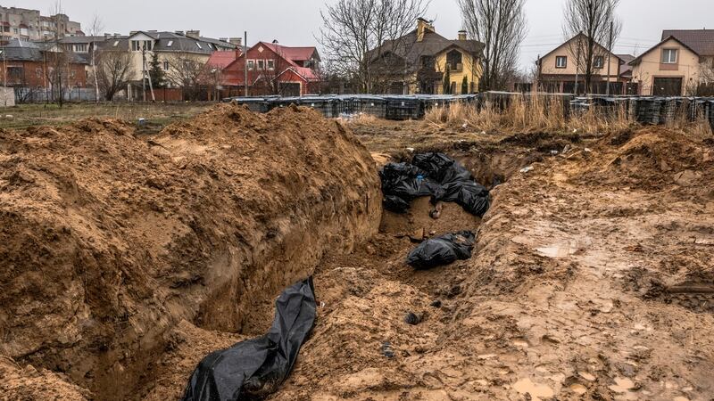 Bodies of civilians who authorities say were killed by Russian forces lay in a mass grave outside St. AndrewÕs Church in Bucha, Ukraine, on Sunday, April 3rd, 2022. Photograph: Daniel Berehulak/The New York Times