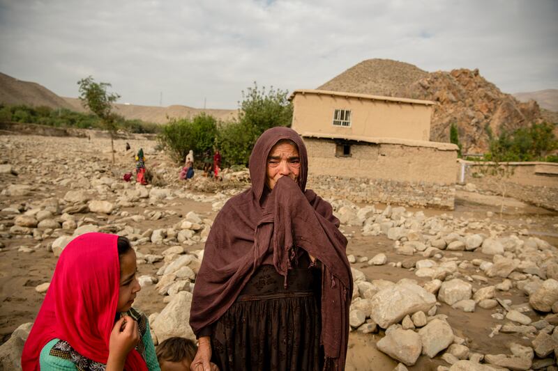 Residents after a flash flood that devastated several villages in Shinwari, eastern Afghanistan. Photograph: Kiana Hayeri/New York Times