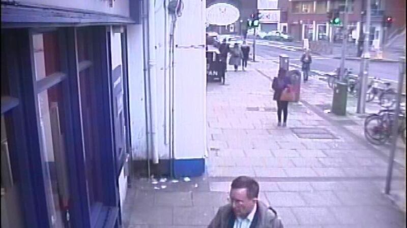 He is described as being 5’11”, of medium build, with dark brown hair.