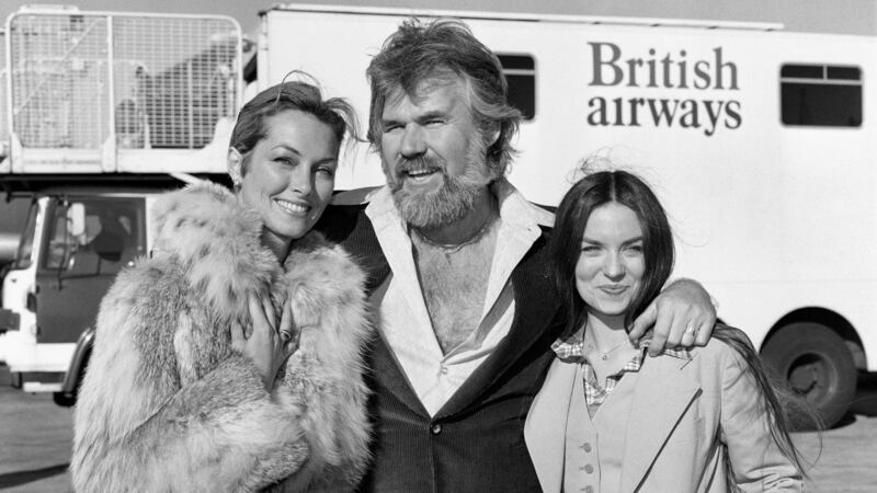 Kenny Rogers at London’s Heathrow airport in 1977  with his wife of a few weeks, television star Marianne Gordon (left) and singer Crystal Gayle. Photograph: PA Wire