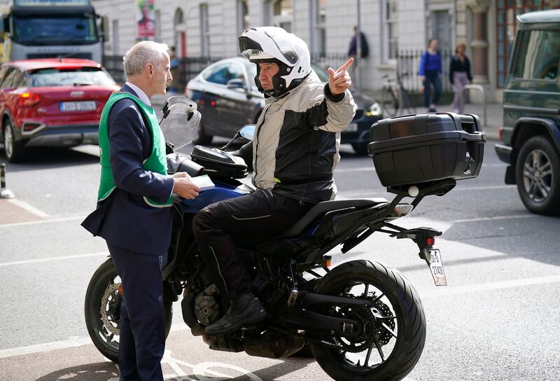 Green Party MEP Ciaran Cuffe speaking to a motorcyclist as he canvases for votes on Pearse Street in Dublin. Photograph: Niall Carson/PA Wire