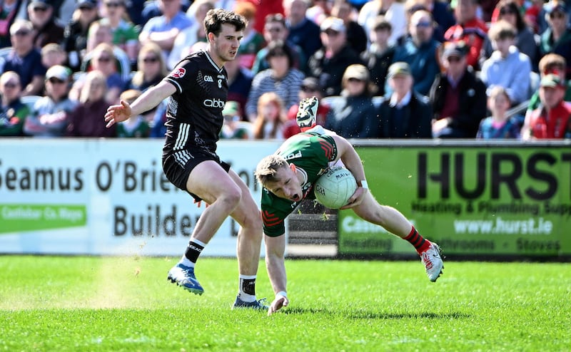 Ryan O’Donoghue of Mayo is tackled by Canice Mulligan of Sligo during the Connacht SFC quarter-final in Castlebar. Photograph: Andrew Paton/Inpho
