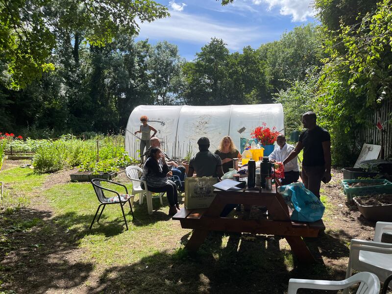 Community members enjoy a picnic after the work is done in the garden. Photograph: Deirdre Falvey