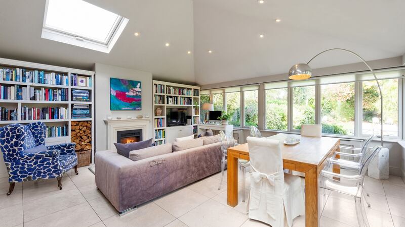 The open-plan dining/living area features built-in shelves.