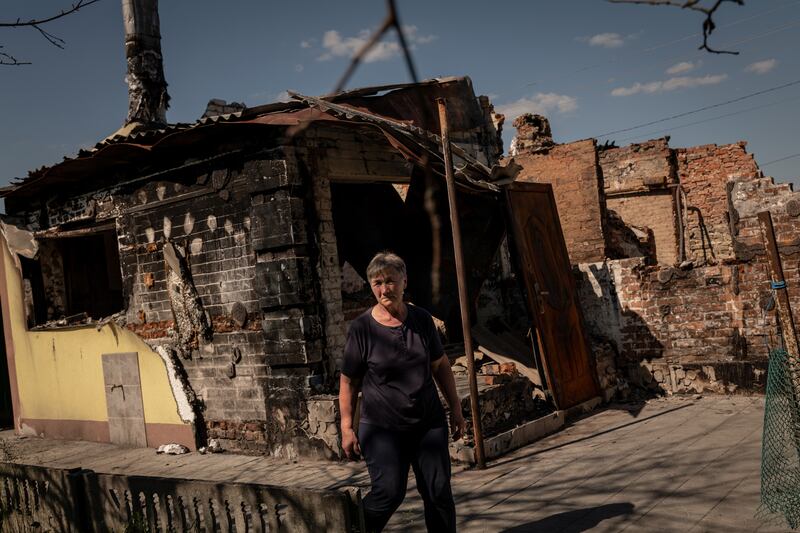Olga Navozenko (64), outside the destroyed home of her sister in the village of Novoselivka, Ukraine. In the Ukrainian villages near the Russian border, shells still explode and checkpoints and trenches dot the landscape as wary civilians live in fear the enemy will return. Photograph: Nicole Tung/New York Times