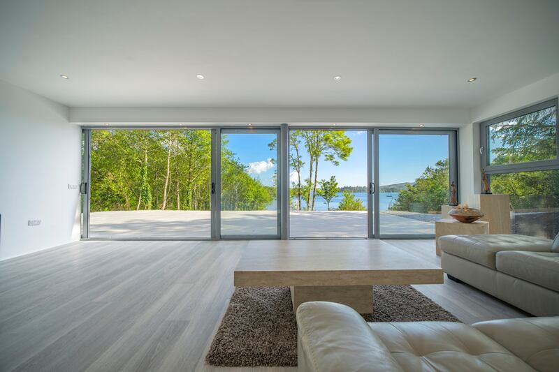 The downstairs living room. There are large windows everywhere. Photograph: Jakub Walutek