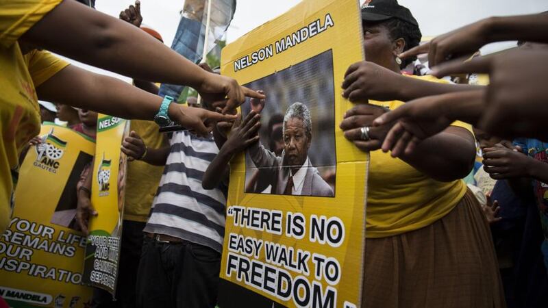 ANC supporters show their respect for Nelson Mandela outside of his one-time house in Vilakazi Street in Soweto, South Africa. Photograph: Brent Stirton/Getty Images