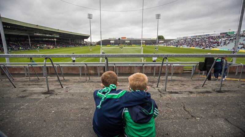 Limerick fans Jonathan and Jamie Byrne watch the minor game ahead of their side’s win over Tipperary. Photograph: Tommy Dickson/Inpho