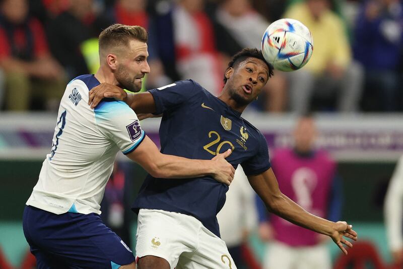 England defender Luke Shaw fights for the ball with France forward Kingsley Coman during their quarter-final match at the Al-Bayt Stadium in Al Khor. Photograph: Adrian Dennis/AFP/Getty Images