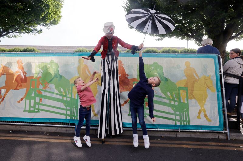 Liam and Jack Fitzgerald reach for the hands of Msdeevadee on the first day of the Dublin Horse Show 2022 at the RDS. Photograph: Alan Betson
