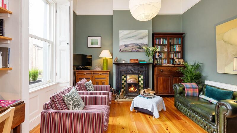 The front reception room is painted in the masculine tone of card room green by Farrow and Ball.