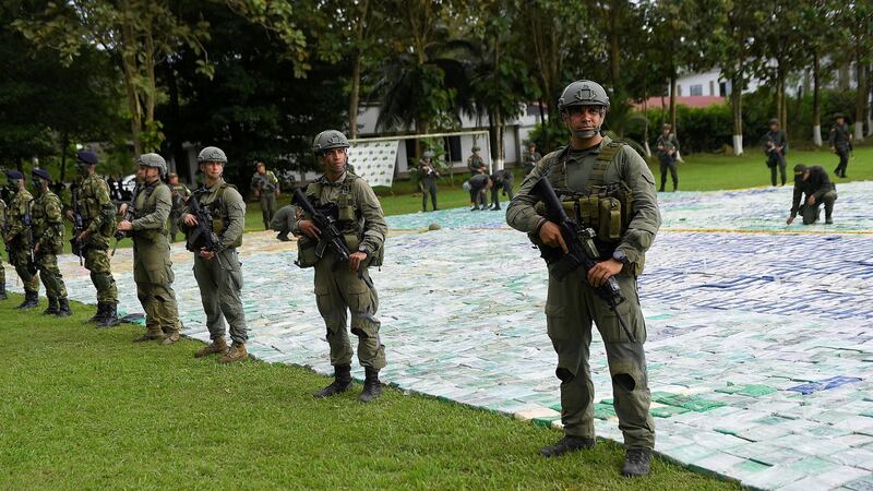Colombian police and soldiers guard more than 12 tons of seized cocaine in Apartado in Colombia. Photograph:  Colombian presidency via Reuters.