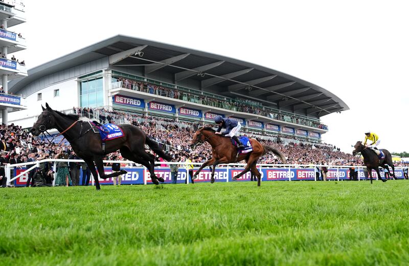City Of Troy ridden by Ryan Moore on the way to winning the Betfred Derby at Epsom Downs Racecourse. Photograph: Adam Davy/PA Wire. .