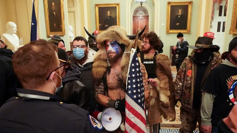 Jacob Anthony Chansley, centre, with other Trump supporters   in the  Capitol  building, in Washington. Photograph: Erin Schaff/ The New York Times
