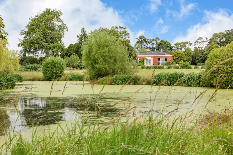 A lake, tennis court and orchard lie on the lands
