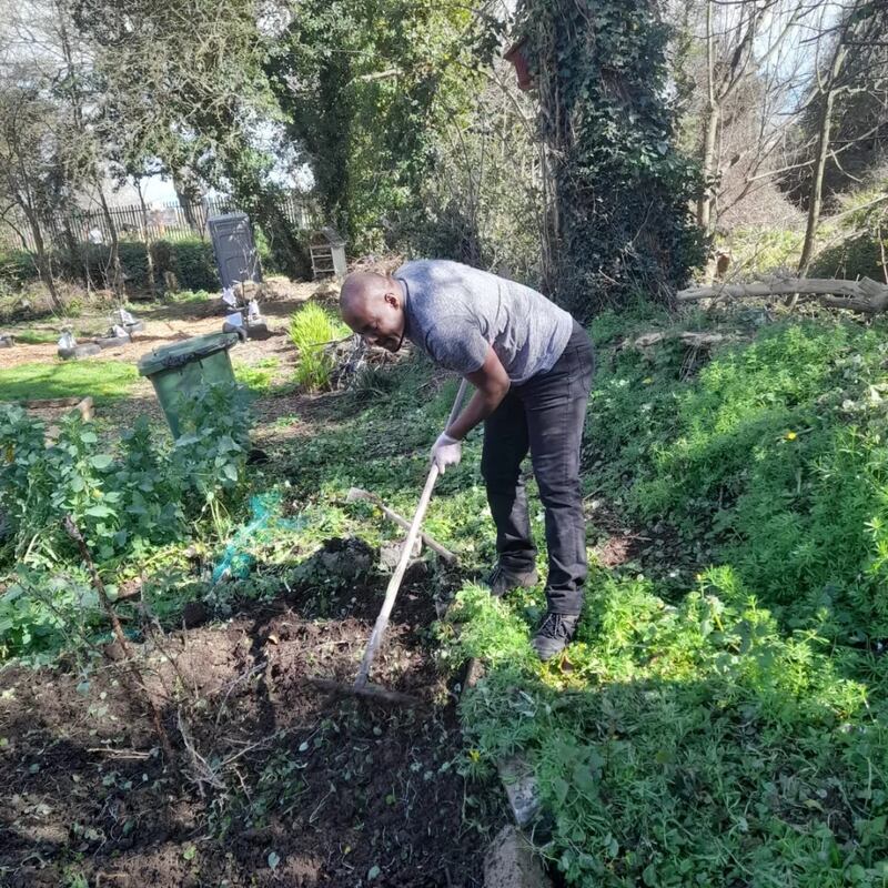 Rasheed Dimeji Basirat digging in the community garden. Photograph: Maeve Murphy